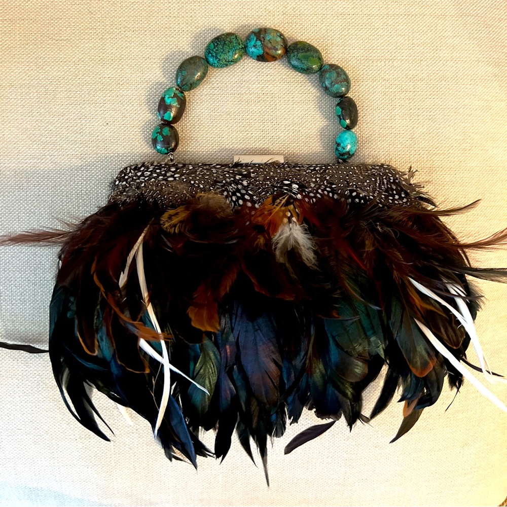 Beautiful handmade feathered bag. Turquoise handle with rhinestone clasp.